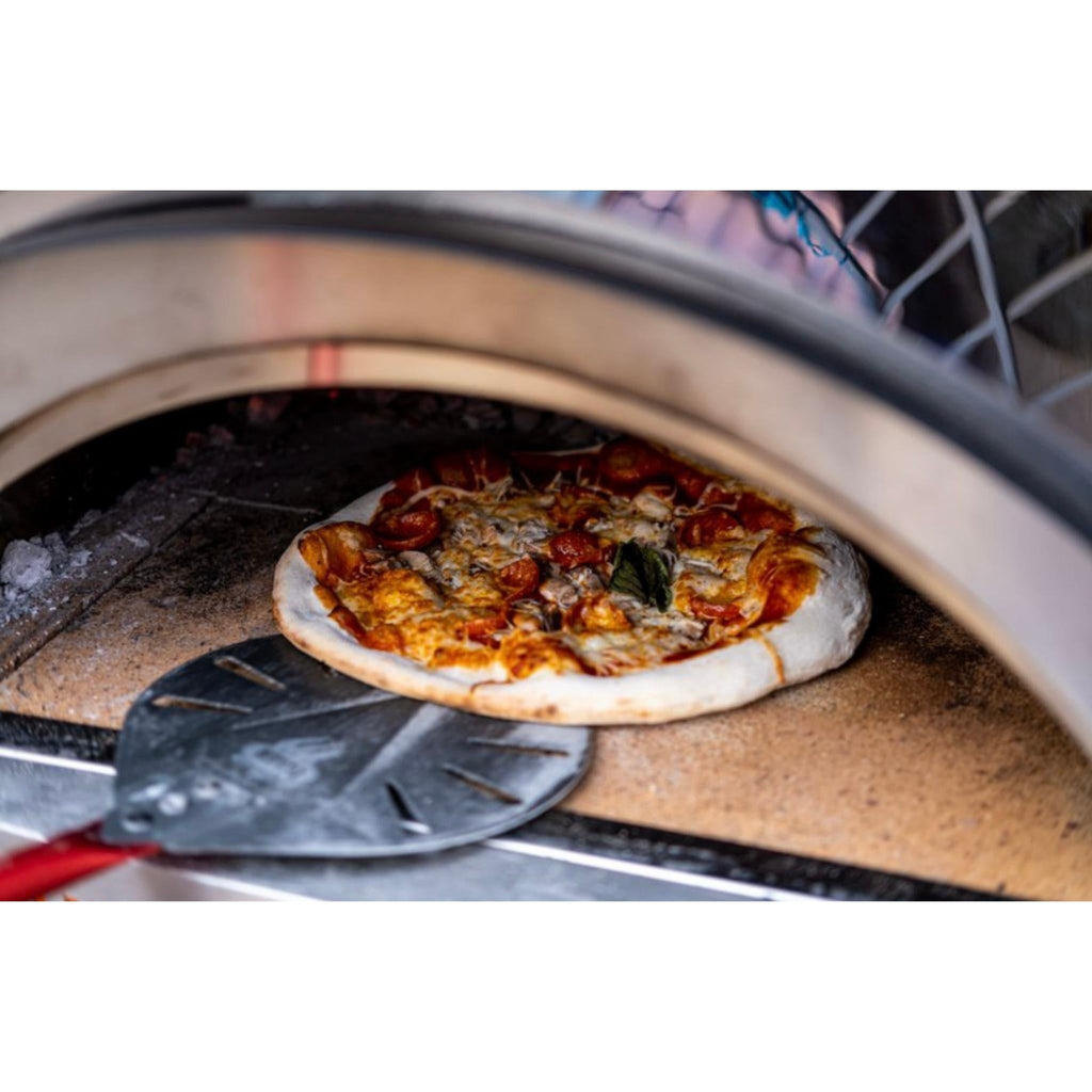 Pizza on a peel at the mouth of the WPPO Karma 25 wood-fired oven